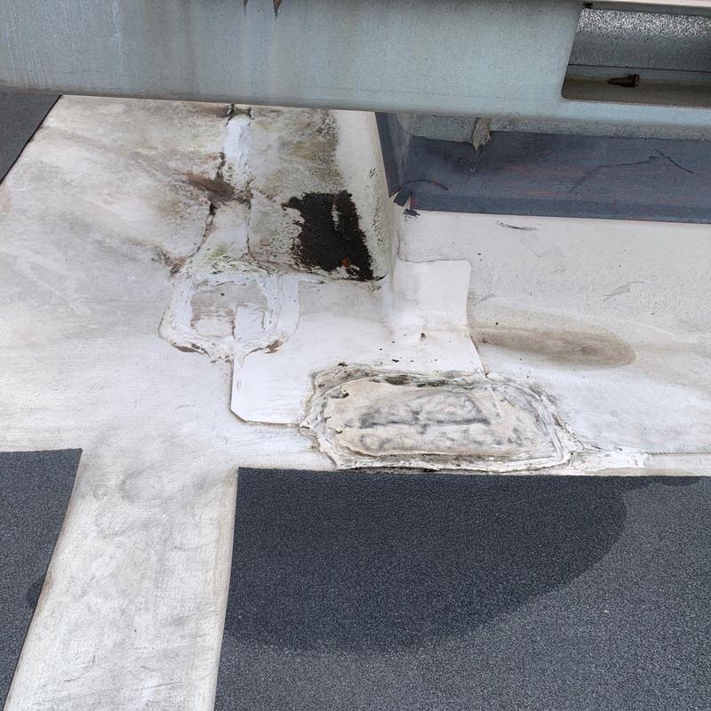 Commercial flat roof damaged membrane with patches