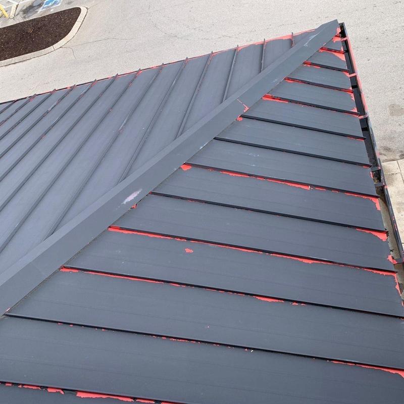 Metal roofing panels with chipped paint and surface wear