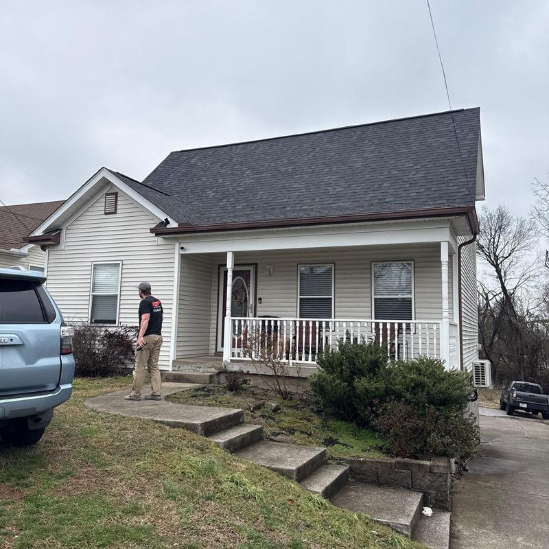 Roof shingles and flashing inspection on house