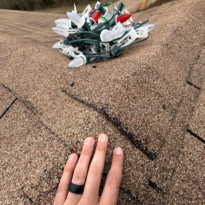 Asphalt shingles with hail damage and roof nails
