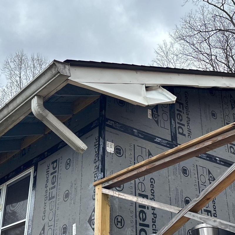 Roof edge trim damage with gutter downspout