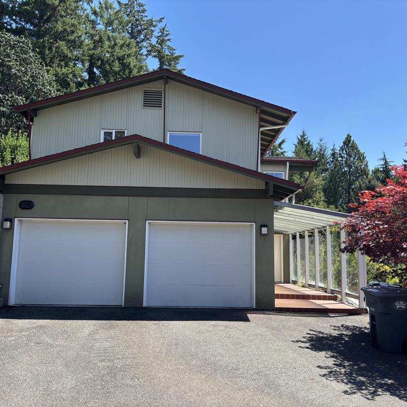 Asphalt shingle roof on two-story home with garage Asphalt shingle roof on two-story home with garage