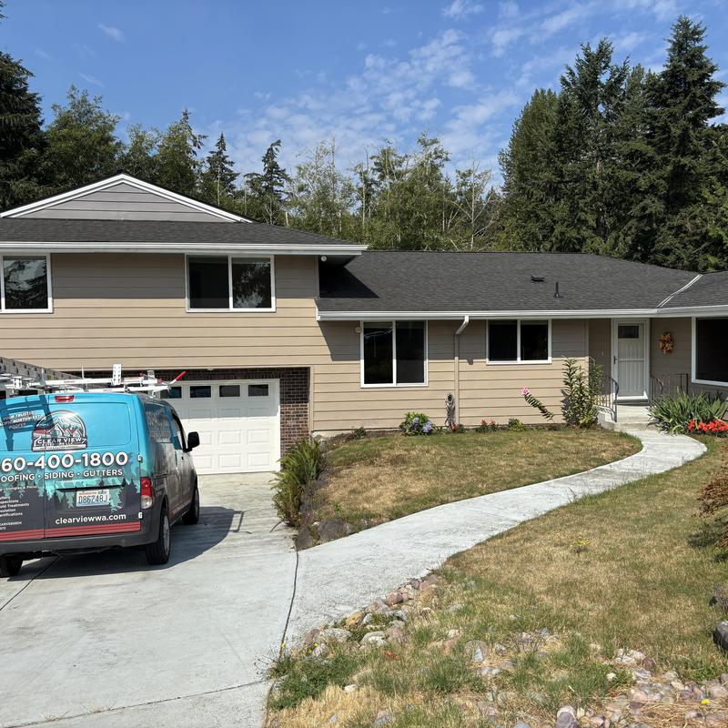 Asphalt shingle roof on residential home with driveway Asphalt shingle roof on residential home with driveway