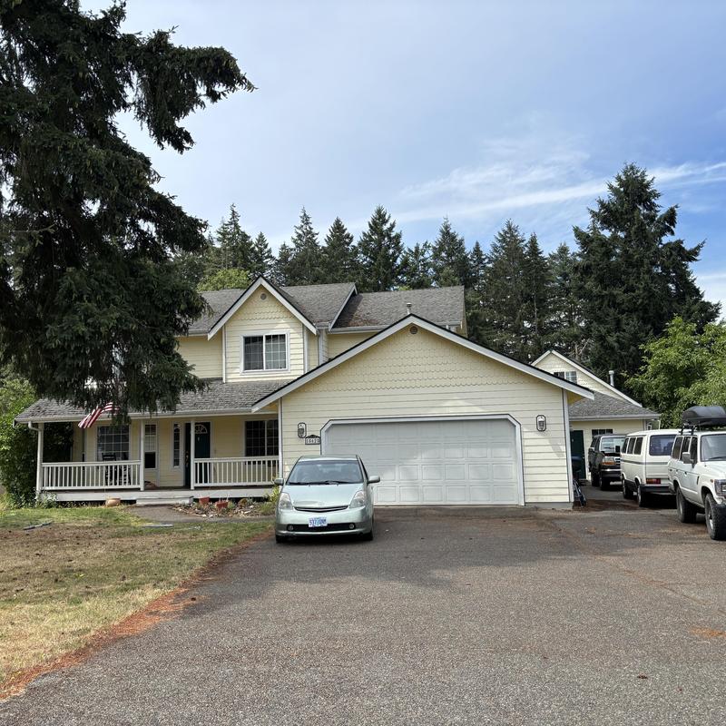 Asphalt shingle roof on two-story house exterior Asphalt shingle roof on two-story house exterior