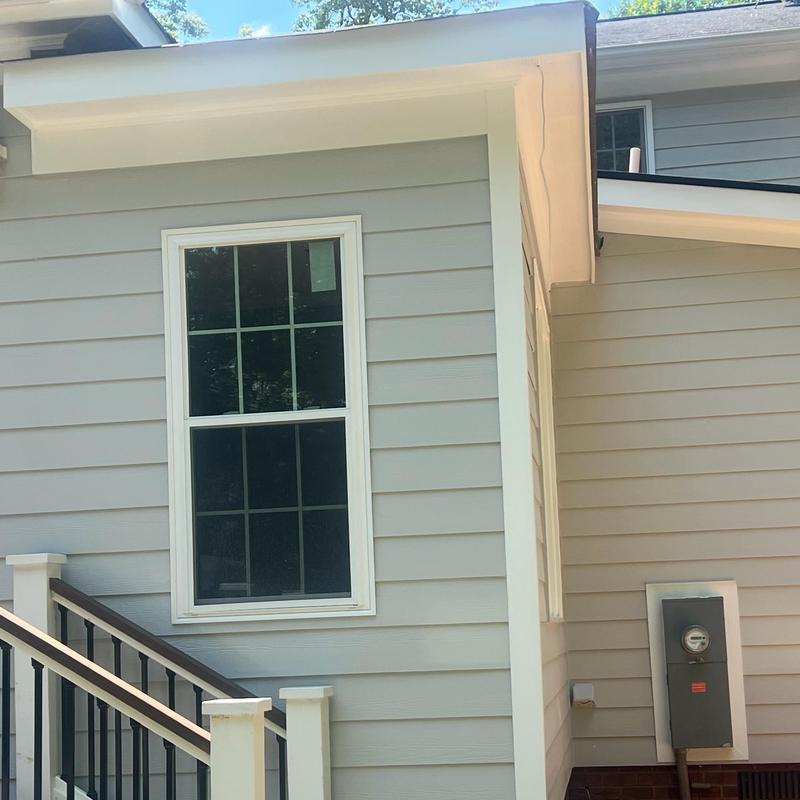 Vinyl siding and window installation on home addition