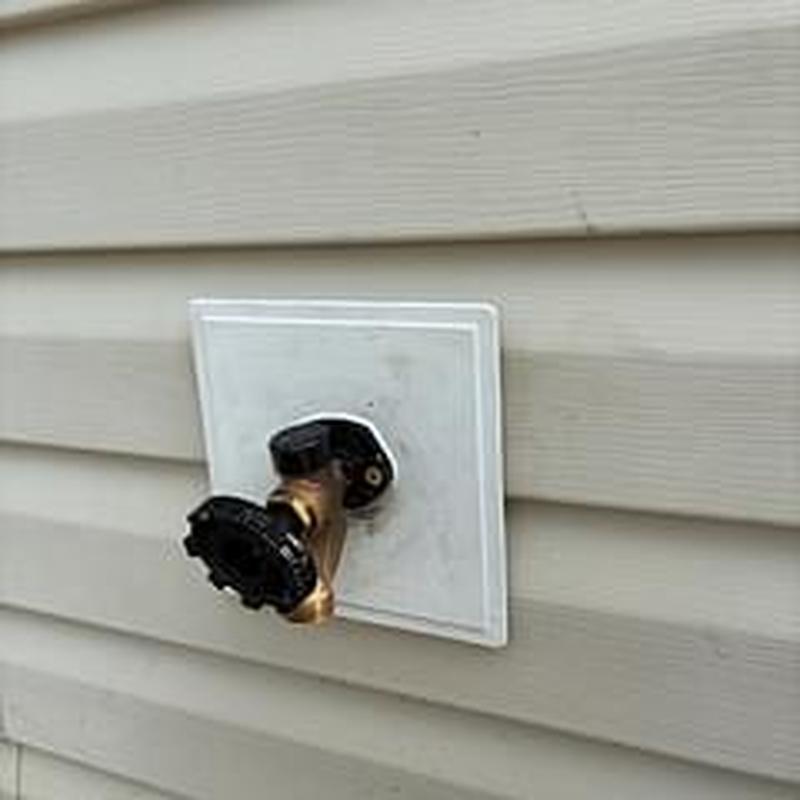 Outdoor hose bib on home exterior siding