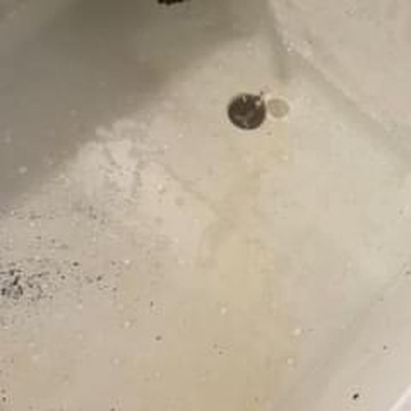 Basement drain with cleaning tool inside drain opening
