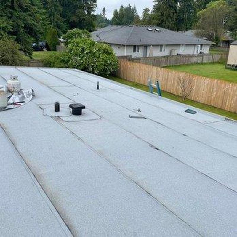 Flat roof with vents and propane tanks in backyard Flat roof with vents and propane tanks in backyard