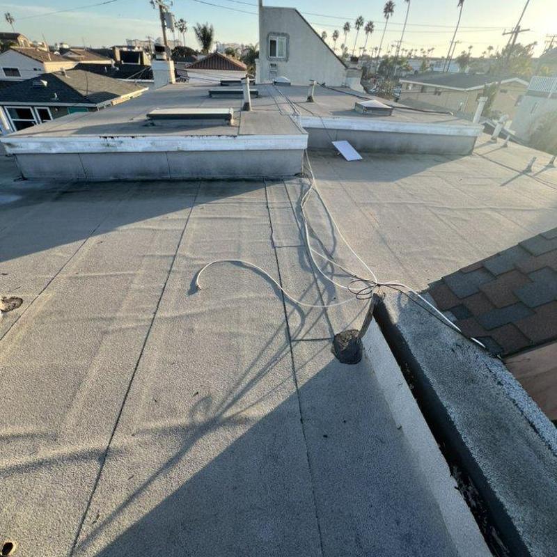 Flat roof membrane inspection with visible wiring Flat roof membrane inspection with visible wiring