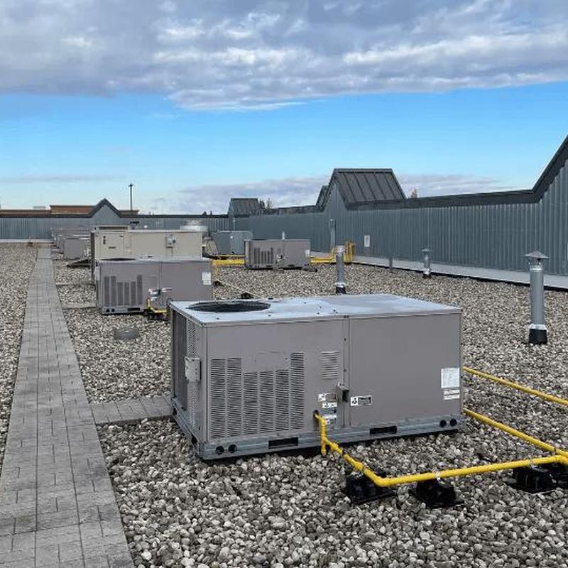 Commercial rooftop HVAC units with gas piping on gravel roof Commercial rooftop HVAC units with gas piping on gravel roof