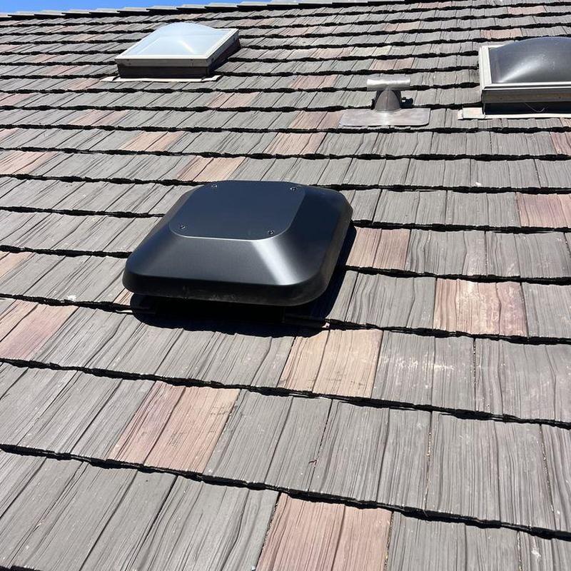 Tile roof with black roof vent and skylights Tile roof with black roof vent and skylights