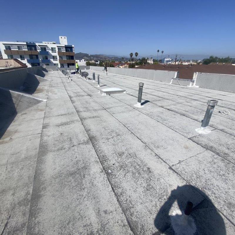 Flat roof surface with vent pipes during inspection Flat roof surface with vent pipes during inspection