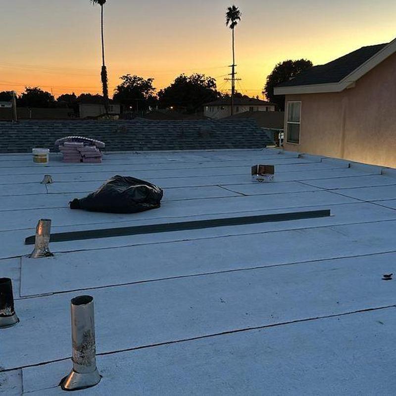 Flat roof membrane installation at sunset in La Habra Heights Flat roof membrane installation at sunset in La Habra Heights