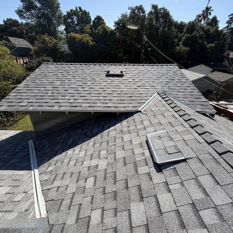 Asphalt shingle roof installation on residential home Asphalt shingle roof installation on residential home