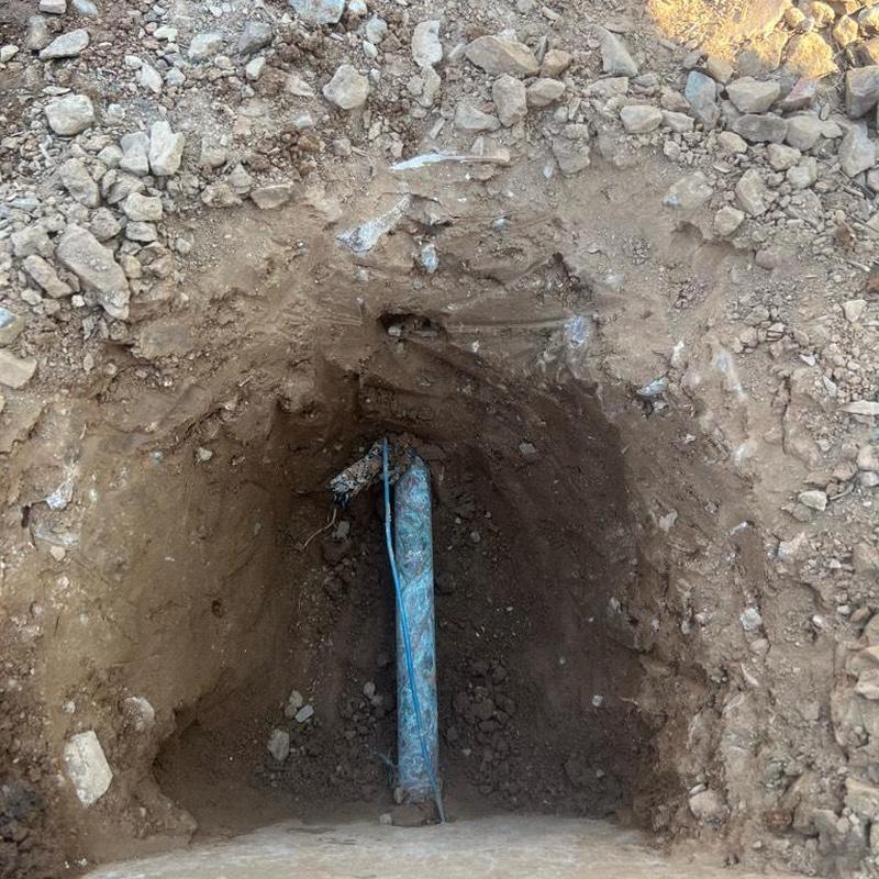 Water service line exposed in dug hole Water service line exposed in dug hole
