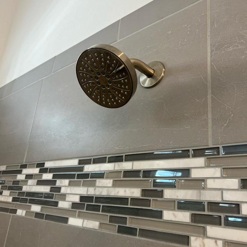 Showerhead installation on tiled bathroom wall Showerhead installation on tiled bathroom wall