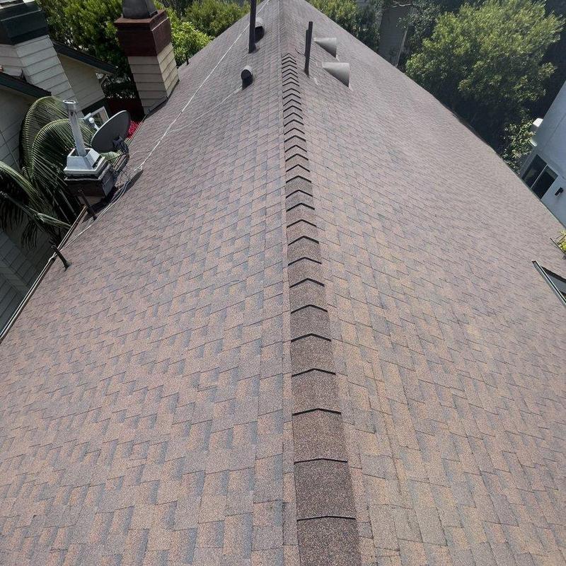 Shingle roof ridge inspection on residential home Shingle roof ridge inspection on residential home