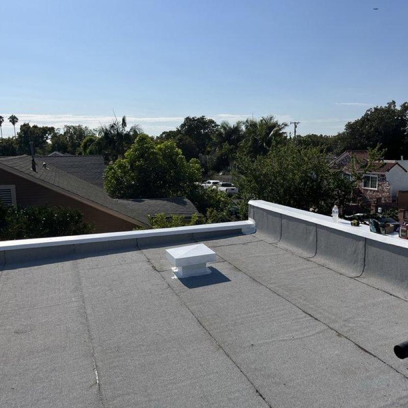 Flat roof membrane with vent pipe on residential building Flat roof membrane with vent pipe on residential building