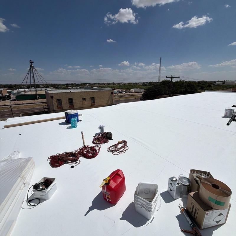 TPO retrofit roofing system with tools on roof