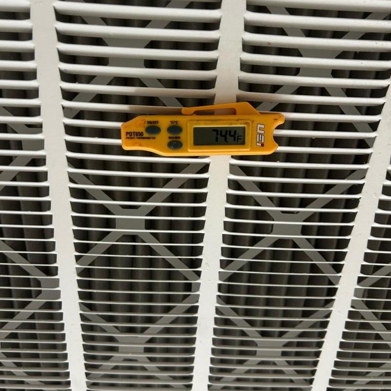 AC unit grille with digital thermometer reading 74.4°F AC unit grille with digital thermometer reading 74.4°F