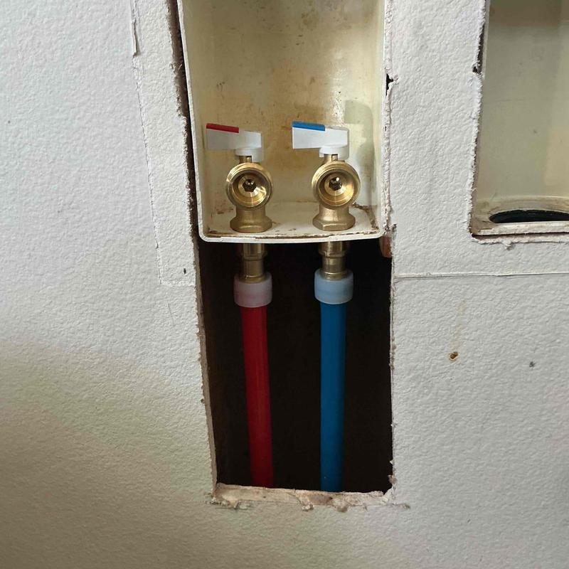 Washing machine valves with red and blue water lines Washing machine valves with red and blue water lines