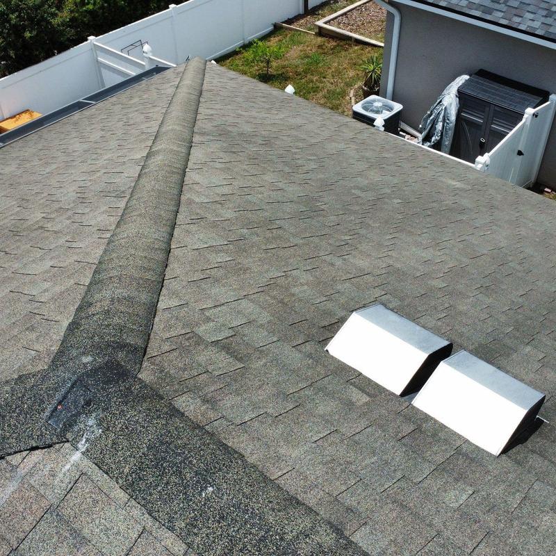 Asphalt shingle roof with metal vents and ridge cap