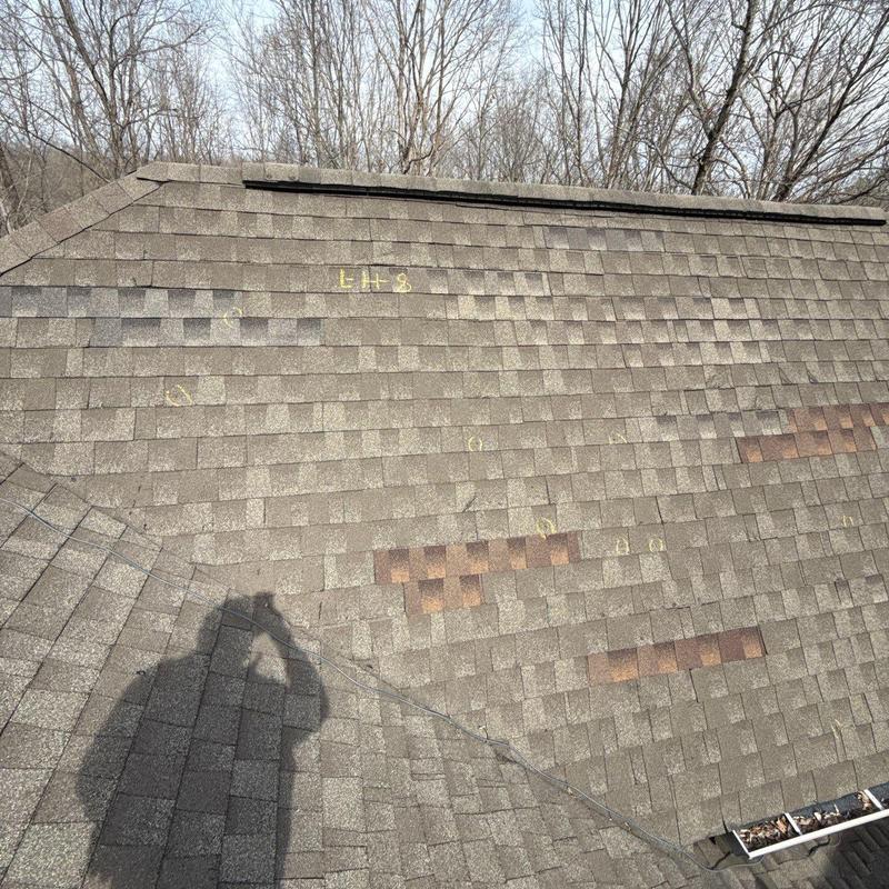 Asphalt shingle roof with hail damage markings