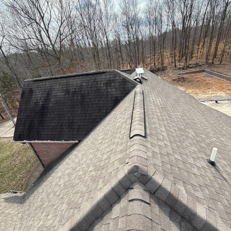 Asphalt shingle roof inspection showing ridge vent and flashing