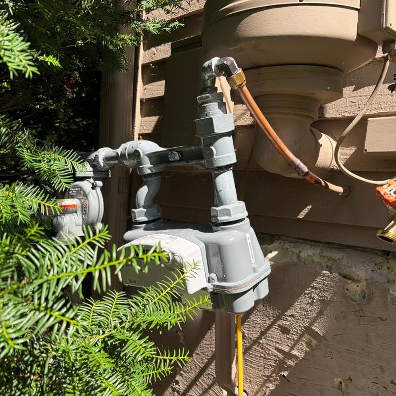 Gas meter and copper piping outside home Gas meter and copper piping outside home