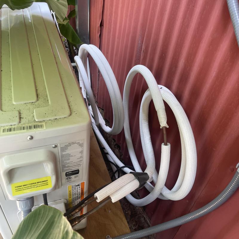 Mini split line set and drain tubing unsecured outside wall