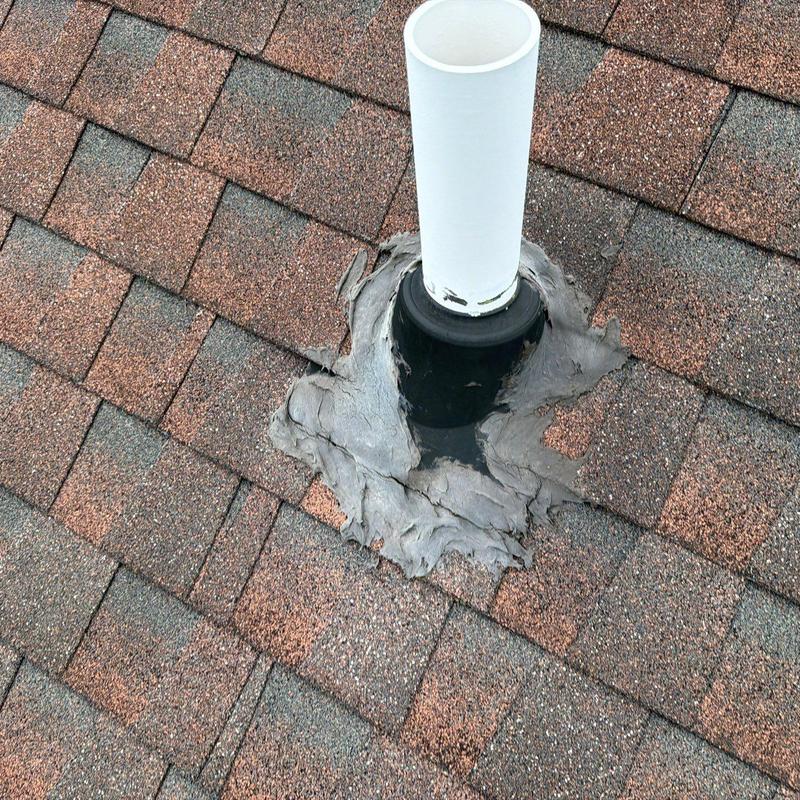 Roof vent pipe flashing with worn sealant on shingles