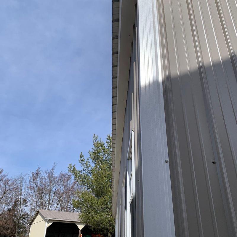 Metal siding panel installation with window and trim