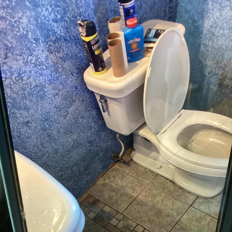 Bathroom toilet drain vent cleared of clog on metal roof