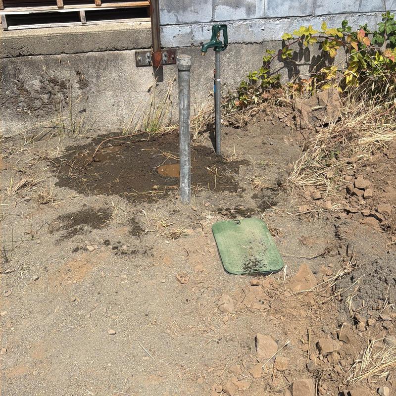 Water meter and piping excavation site near foundation wall