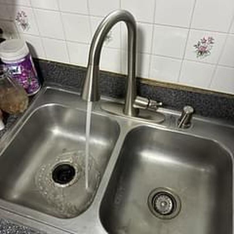 Kitchen faucet with running water on double sink