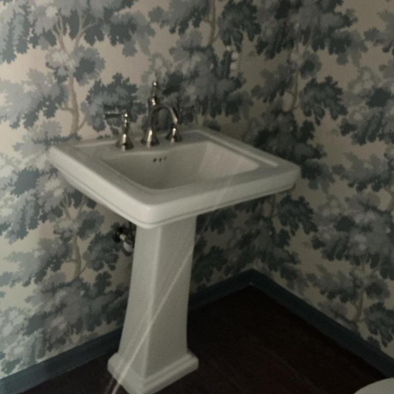 Pedestal sink with chrome faucet installed in bathroom corner Pedestal sink with chrome faucet installed in bathroom corner