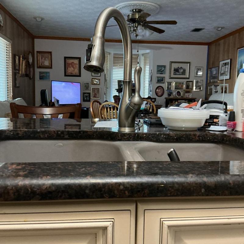 Kitchen faucet with loose components on granite counter Kitchen faucet with loose components on granite counter