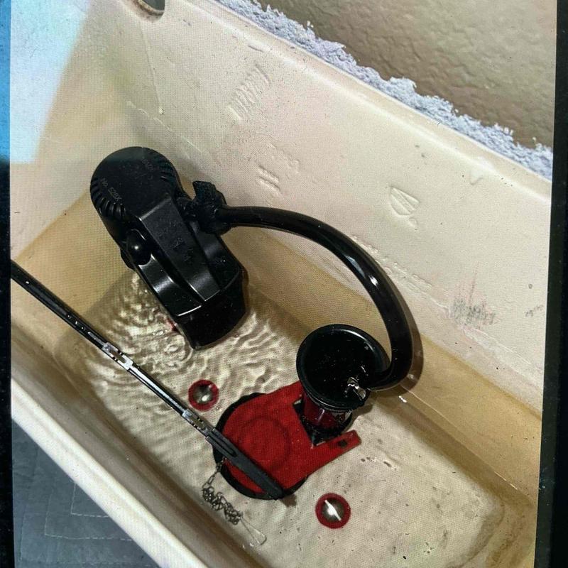 Toilet fill and flush valve with red flapper installed Toilet fill and flush valve with red flapper installed