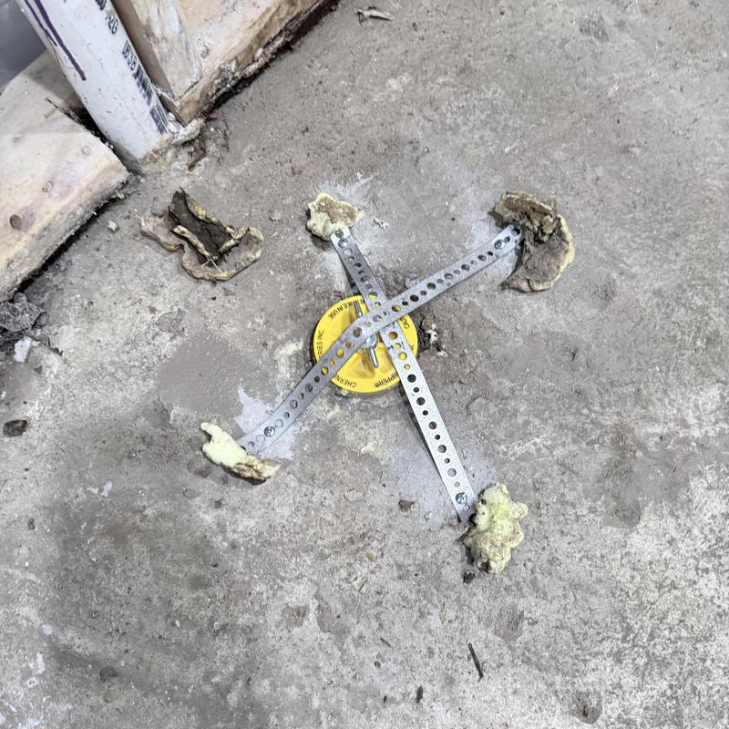 Backwater valve with metal braces in basement floor Backwater valve with metal braces in basement floor