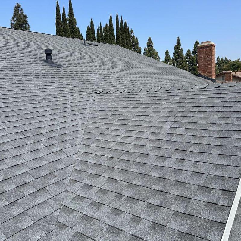 Gray shingle roof with vent pipe and chimney Gray shingle roof with vent pipe and chimney