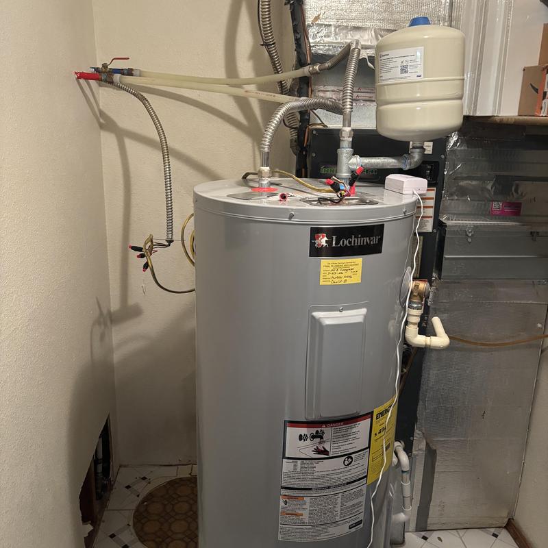 Water heater with attached expansion tank and piping Water heater with attached expansion tank and piping