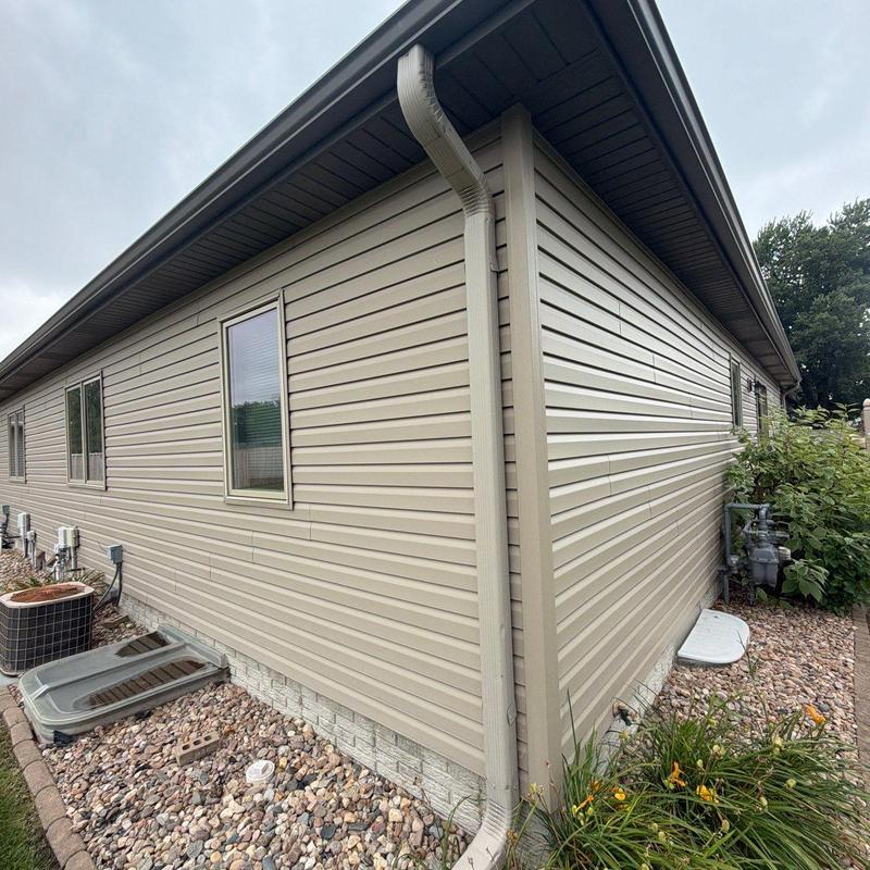Vinyl siding and gutter system on residential building Vinyl siding and gutter system on residential building