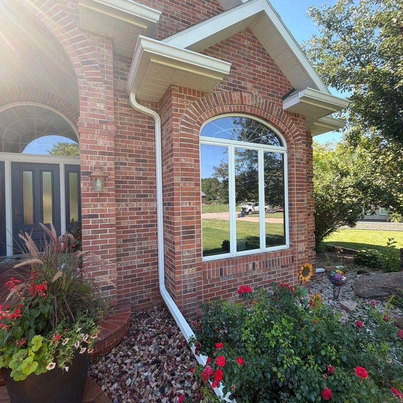 Gutter system on red brick home with landscaping Gutter system on red brick home with landscaping