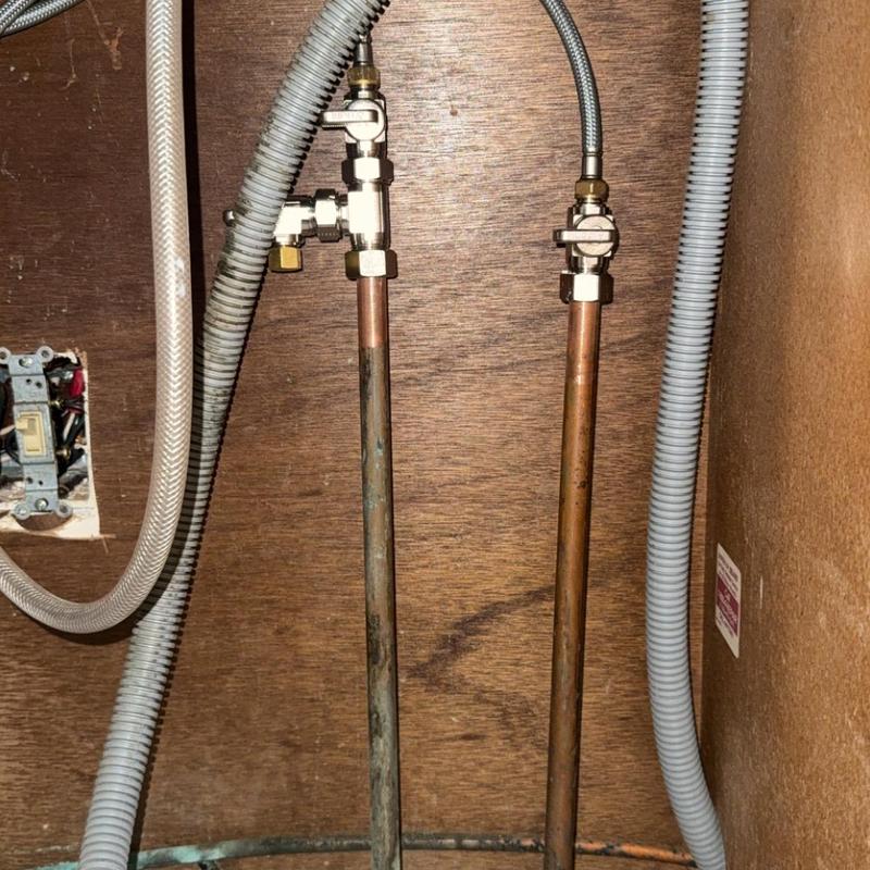 Copper water supply pipes with shutoff valves under sink Copper water supply pipes with shutoff valves under sink
