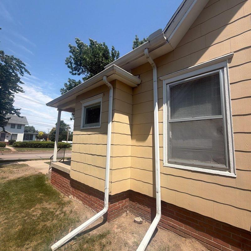 Gutter downspouts on residential house exterior Gutter downspouts on residential house exterior