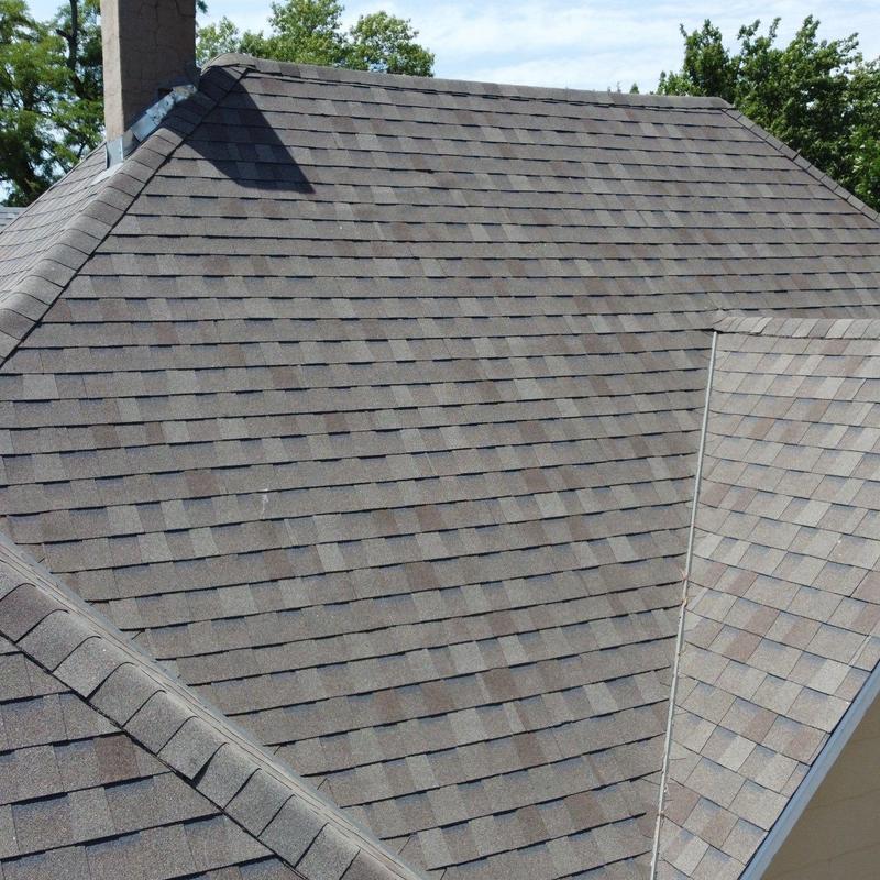 Asphalt shingle roof with chimney, no damage visible Asphalt shingle roof with chimney, no damage visible