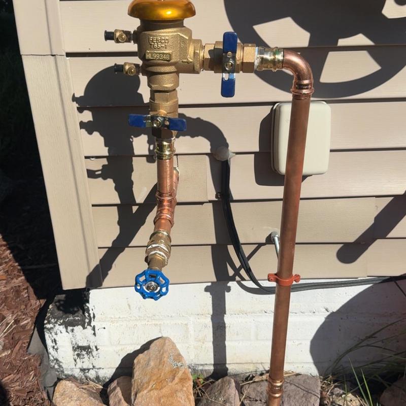 Vacuum breaker valve with copper piping outdoors Vacuum breaker valve with copper piping outdoors