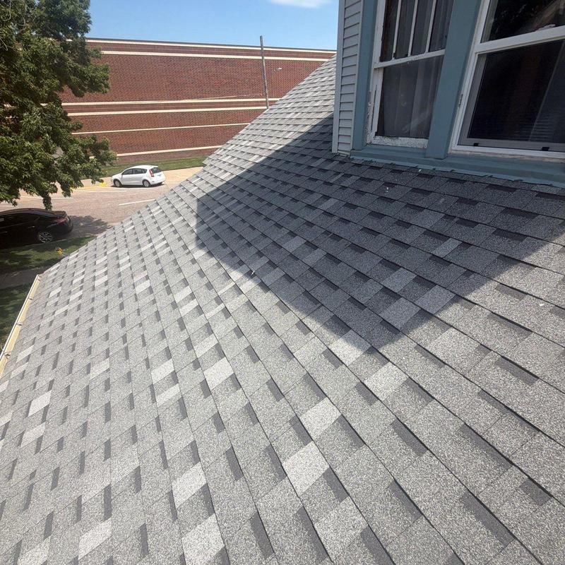 Asphalt shingle roof inspection near window on house Asphalt shingle roof inspection near window on house
