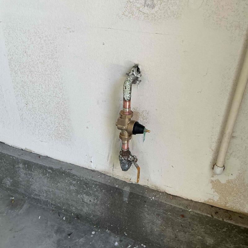 Pressure regulator valve and piping on exterior wall Pressure regulator valve and piping on exterior wall