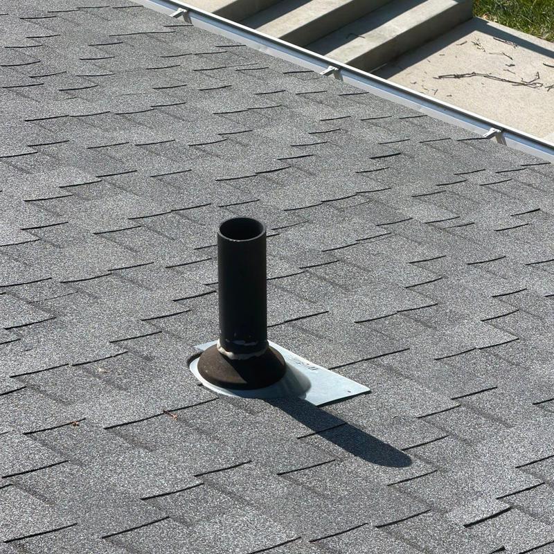 Roof vent pipe and shingle roof overview under sunlight Roof vent pipe and shingle roof overview under sunlight